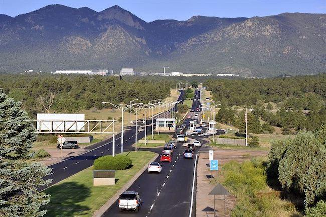 cars driving towards mountains