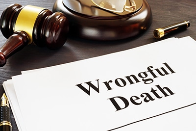 Wrongful Death report next to a gavel on a desk - McDivitt Law Firm